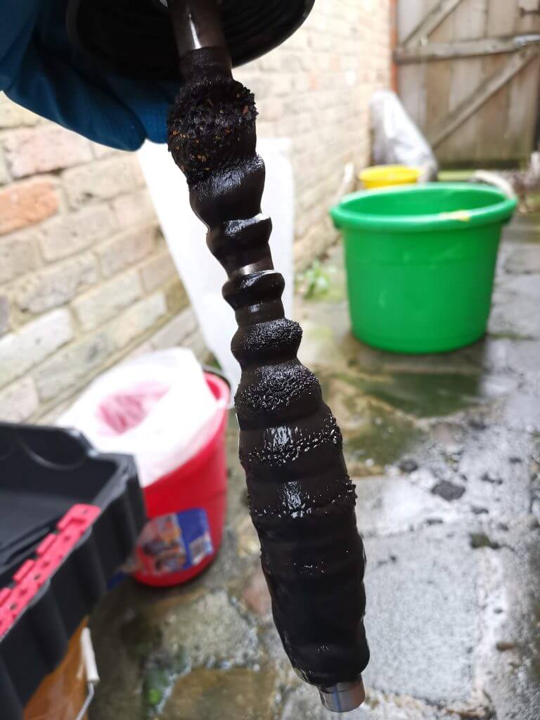 Magnetic filter full of sludge removed during a powerflush